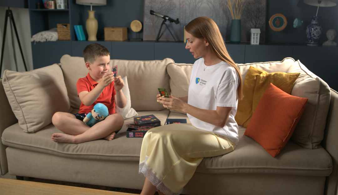 A Children of Heroes case manager talking with a child in Ukraine